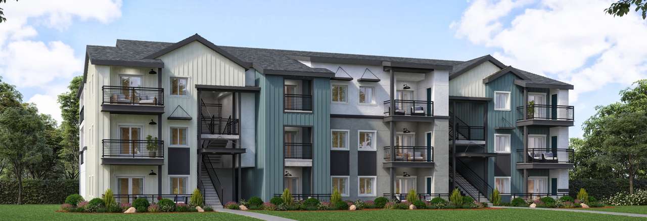 Architectural rendering of a modern three-story apartment building with exterior staircases, balconies, and a mix of vertical siding in muted tones, surrounded by landscaping and trees.