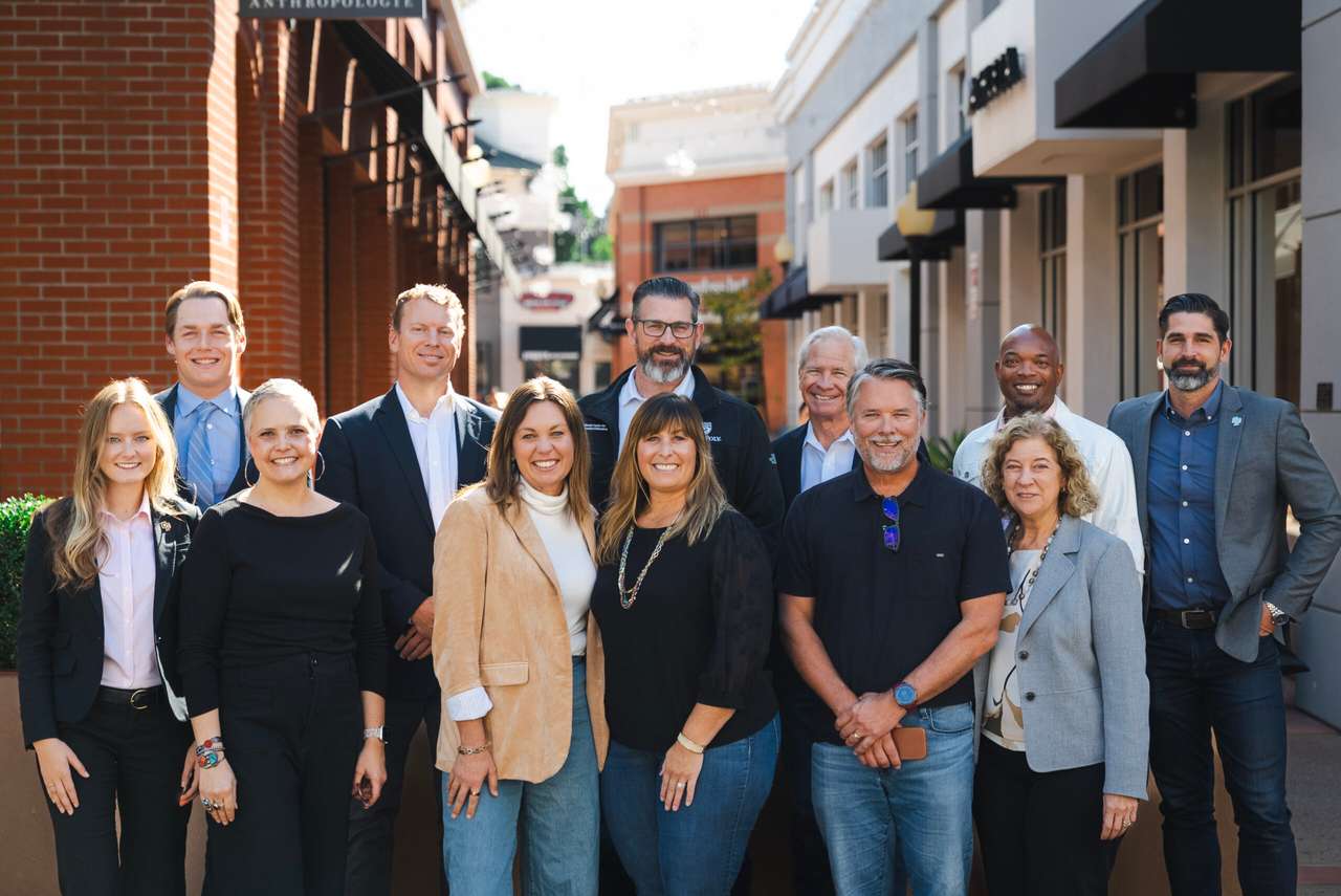 Group of Cal Poly Partners board members standing together outdoors in downtown San Luis Obispo, smiling for a professional group photo.